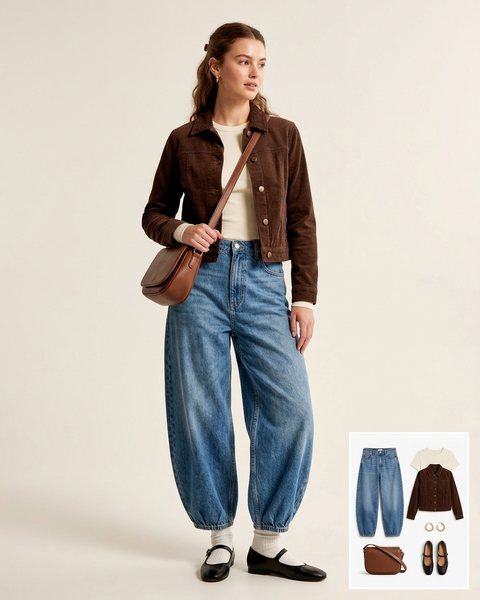 Woman wearing mid-wash balloon-leg jeans with a cream long-sleeve tee, a brown corduroy jacket, black Mary Jane flats and a brown crossbody bag