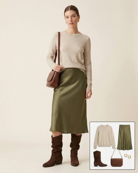 Woman wearing chocolate suede slouchy boots with an olive satin midi skirt, an oatmeal sweater and a brown leather shoulder bag