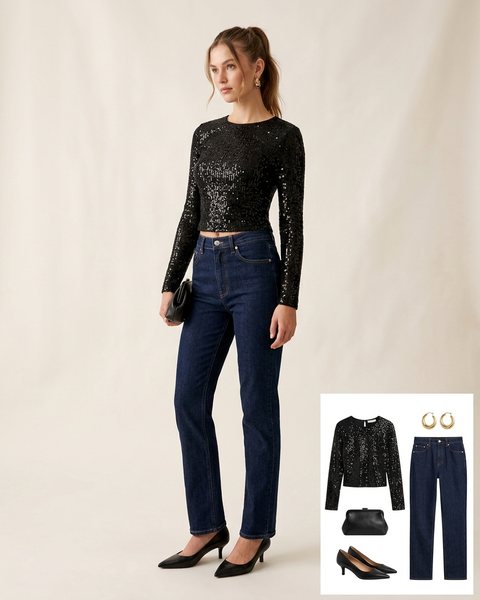 Woman wearing a black sequin long-sleeve top with dark straight jeans, black kitten-heel pumps and a black clutch