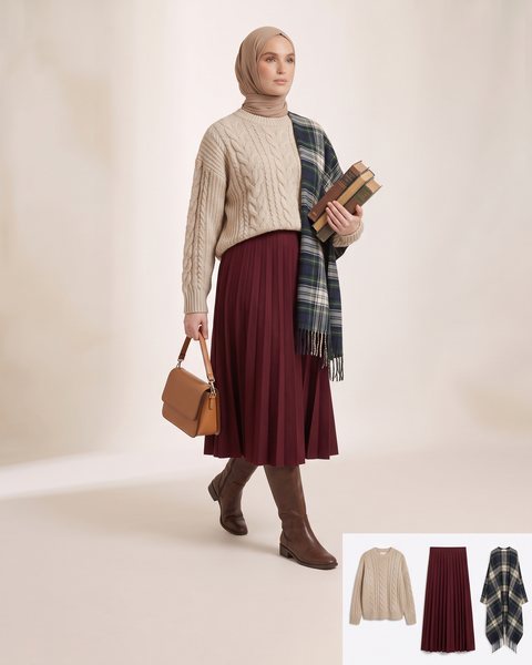 Chunky cable-knit sweater tucked into a box-pleat midi skirt, styled for a study day