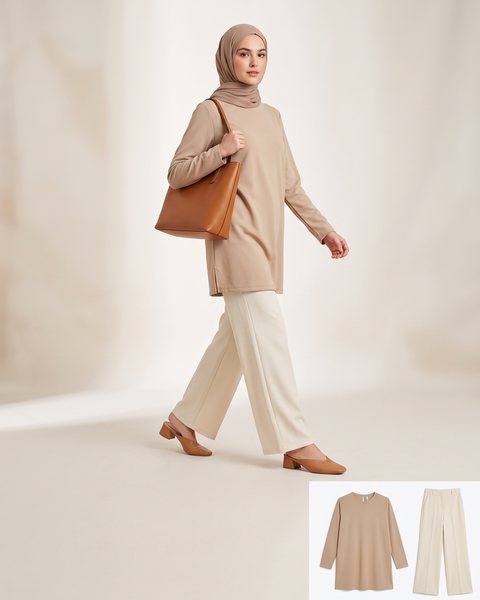 Beige longline tunic tucked loosely over wide-leg trousers with a structured tote, styled for the office