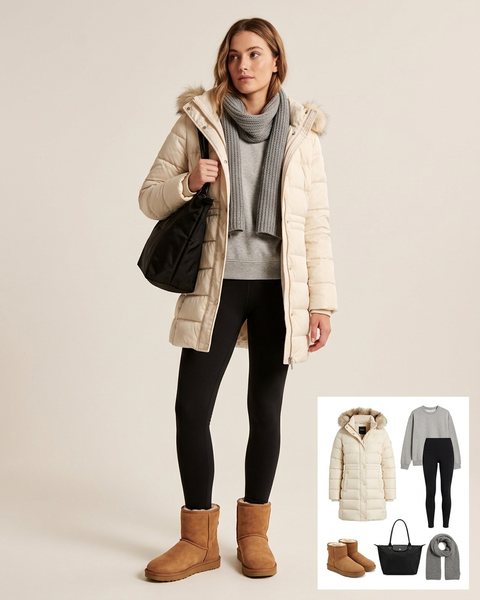 Woman wearing a cream hooded puffer parka with a grey sweatshirt, black leggings, tan shearling-lined boots, a black tote bag and a grey scarf