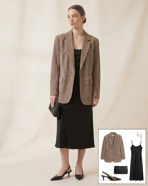 Woman wearing a taupe suede oversized blazer with a black satin slip dress, black slingback heels and a black clutch