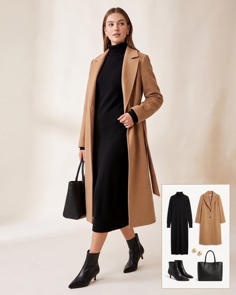 Woman wearing a black fine-knit midi sweater dress under an open camel wool coat with pointed black kitten-heel ankle boots and a black leather tote