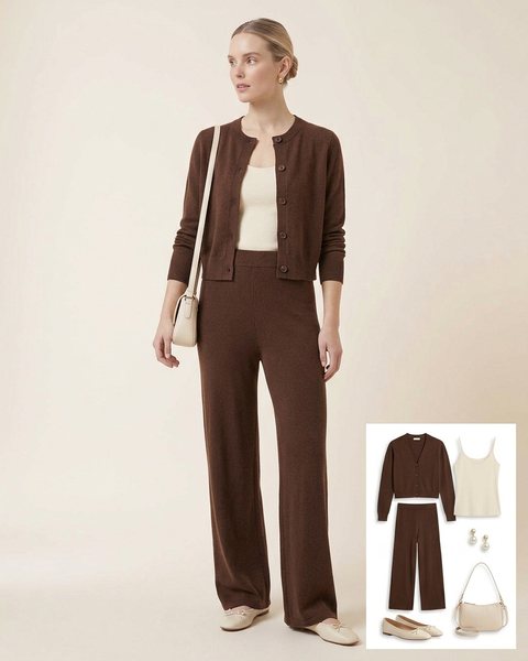 Woman wearing a chocolate brown knit set with a cropped cardigan over a cream camisole, wide-leg knit pants, cream ballet flats and a cream shoulder bag